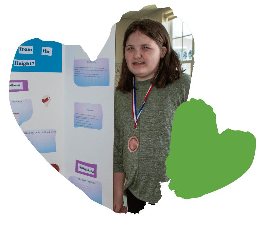 girl poses with her poster board presentation