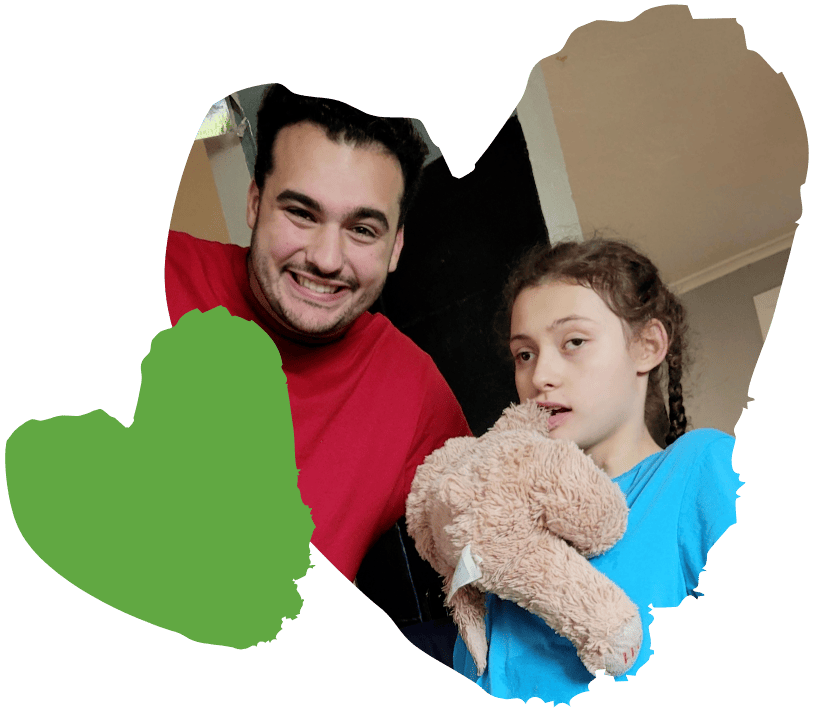 spaulding staff member and student holding teddy bear pose for picture