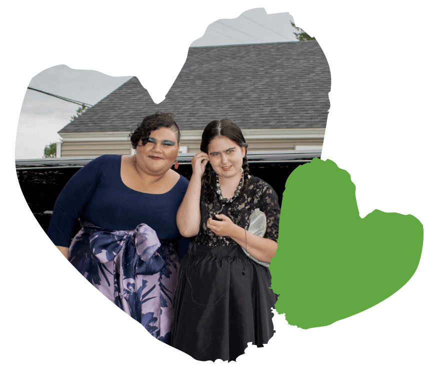 two spaulding students smile infront of limo outside before prom